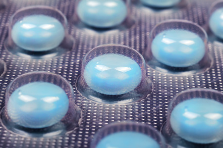 blue tablets in a package, close up