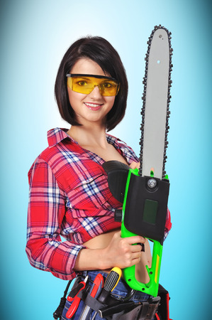 sexy girl with chainsaw on a blue backgroundの写真素材