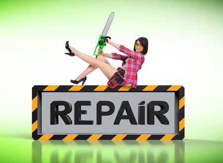 sexy girl with electric saw and repair symbolの写真素材