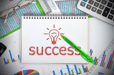 notebook with drawing success and financial chartsの写真素材