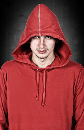 teenager with red hoodie on a black backgroundの写真素材