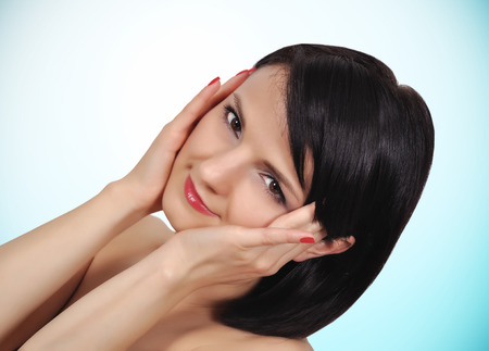Portrait of beauty girl on a blue backgroundの写真素材