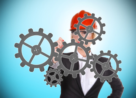 engineer woman drawing cogs and gearsの写真素材
