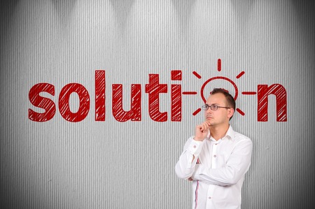 businessman standing near a concrete wall with drawing solution