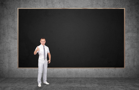 businessman showing thumb up and blank chalk boardの写真素材