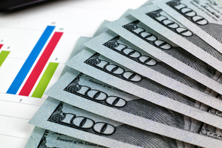 dollar bills and stock chart, close upの写真素材
