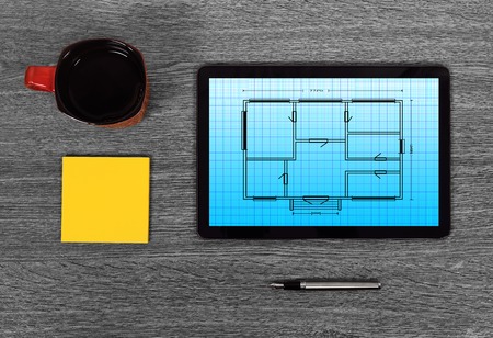 touch pad with blueprint on gray tableの写真素材
