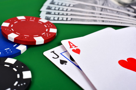 Ace, jack and poker chips on table