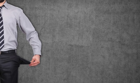 businessman standing with pockets turned inside outの写真素材