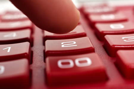 finger pusing calculator buttons, extra close upの写真素材