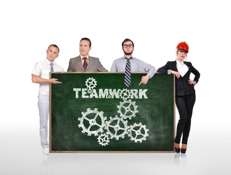 businesspeople holding blackboard with teamwork conceptの写真素材