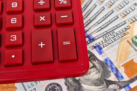 Stack of dollar bills with a calculatorの写真素材