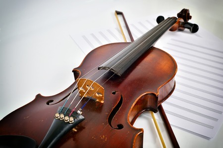 Old violin on notes lies on notesの写真素材