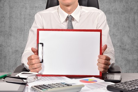 young businessman holaing blank clipboard , close upの写真素材