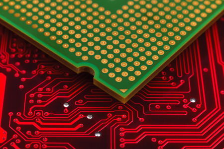 Central Processing Unit on red motherboard, close up