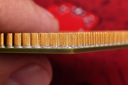 finger holding central processing unit, extra close upの写真素材