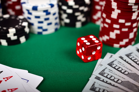 Poker chips, cards, dollar and dice on green tableの写真素材