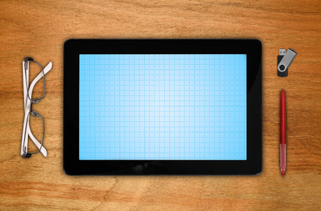 touch pad with blank screen on wooden tableの写真素材