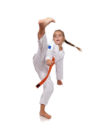 Little girl practice karate on a white backgroundの写真素材