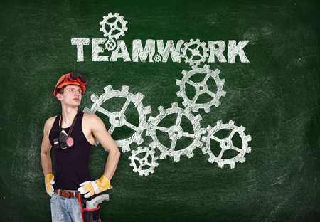 repairman with drill and drawing teamwork concept on blackboardの写真素材