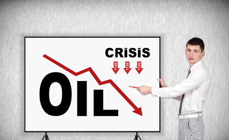 businessman pointin to frame with crisis oil chartの写真素材