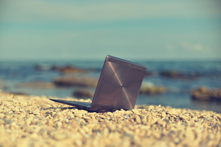 Laptop on beach. Vintage photoの写真素材