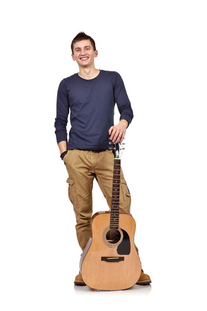 happy young man with acoustic guitar on a white backgroundの写真素材