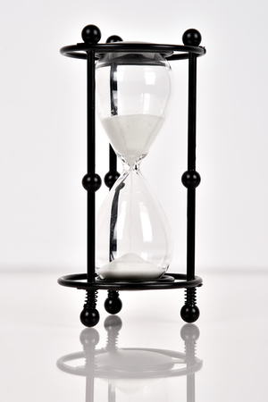 Black sand clock on a white background