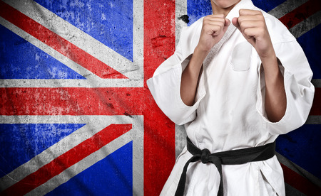 karate fighter in kimono on united kingdom flag backgroundの写真素材
