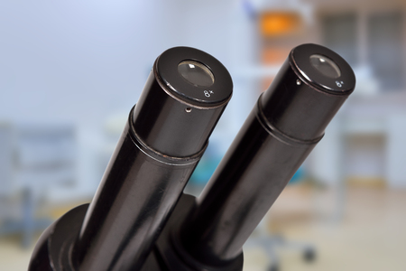 old microscope on a laboratory backgroundの写真素材