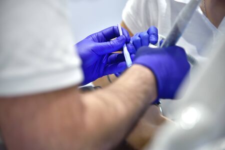 Dentist Surgeon Performing Operation Install Dental Implant Teeth Of Patient. Close Up