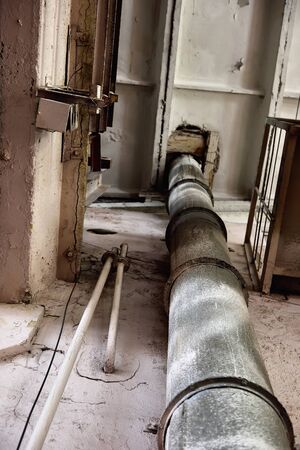 Old empty destroyed and abandoned factory with rusty pipe. industrial concept