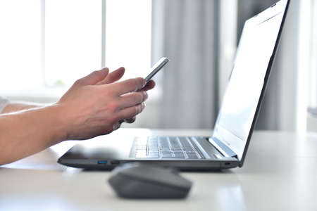 Businessman working in modern office and using smart phone. Technology and communication concept. Close upの写真素材