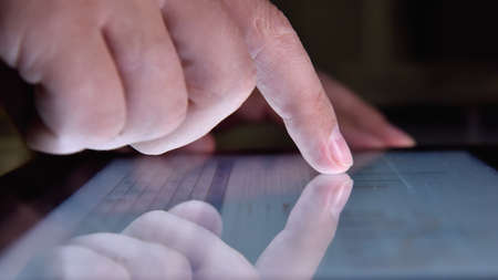 Trader hand using tablet screen with growth of financial stock report. Success and start up concept....
