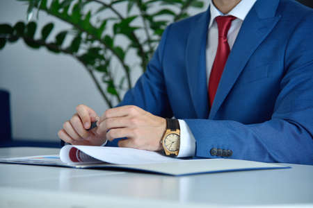 Financial auditor analyzing report in modern office. Business and success concept. Close upの写真素材