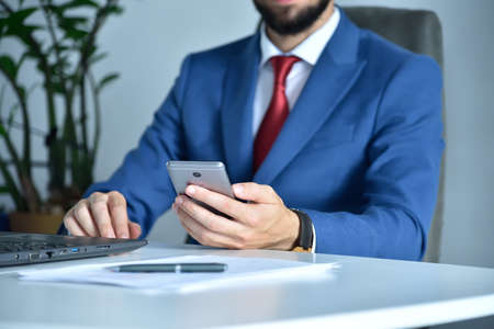 Accountant writes message on smart phone. Business and working concept. Close upの写真素材