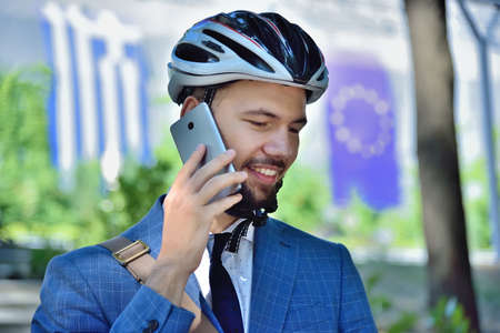 Bearded businessman talking on mobile phone and analyzes report. Business and urban style conceptの写真素材