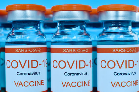 Ampoules with sars-cov-2 vaccine onlaboratory glass table. Medicine and virus infection concept. Close upの写真素材