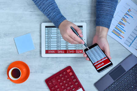 Businessman doing business and charts being demonstrated on screen of a mobile phone. Success and...