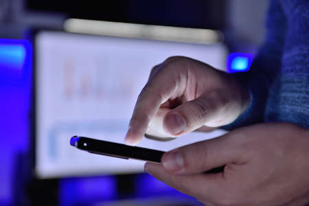 Businessman checks business report on smart phone. Business and financial success concept. Close up