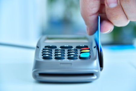 Close up of pay money blue credit card for spending money with payment terminal. Transaction pay and...