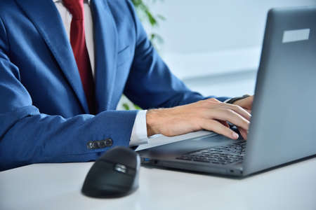 Financial analyst hands typing on laptop keyboard. Occupation and worker concept. Close up