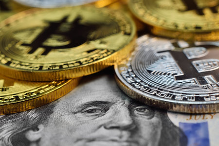 Bitcoin money and 100 dollar banknotes. Cryptocurrency and virtual money concept. Close up