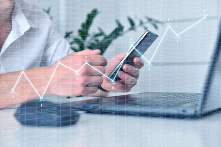 Accountant hand checks business report on smart phone. Business and financial success concept. Close upの写真素材