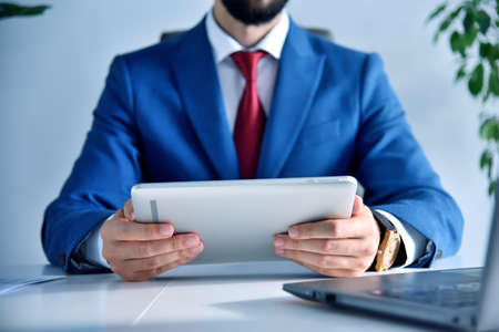 Office manager hands using tablet computer. Business and financial success concept. Close upの写真素材