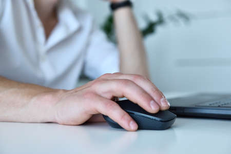 Hand businessman using computer mouse in office. Occupation and worker concept. Close up
