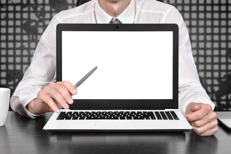 Businessman pointing on blank laptop scree. Trade and finance concept. Close upの写真素材