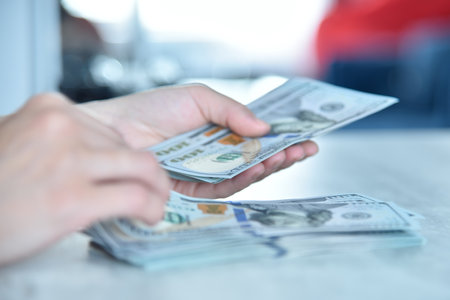 Trader woman hands counting usa dollars on table. Success, business and financial idea concept. close upの写真素材