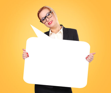 businesswoman holding a blank message board over yellow background, business conceptの写真素材