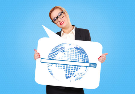 Businesswoman holding a speech bubble with world map and internet concept on it over blue backgroundの写真素材